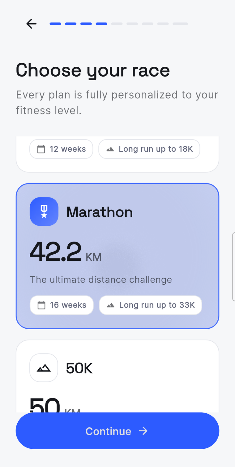 The race selection step of onboarding, showing a marathon option at 42.2 km over 16 weeks with a long run up to 33 km.